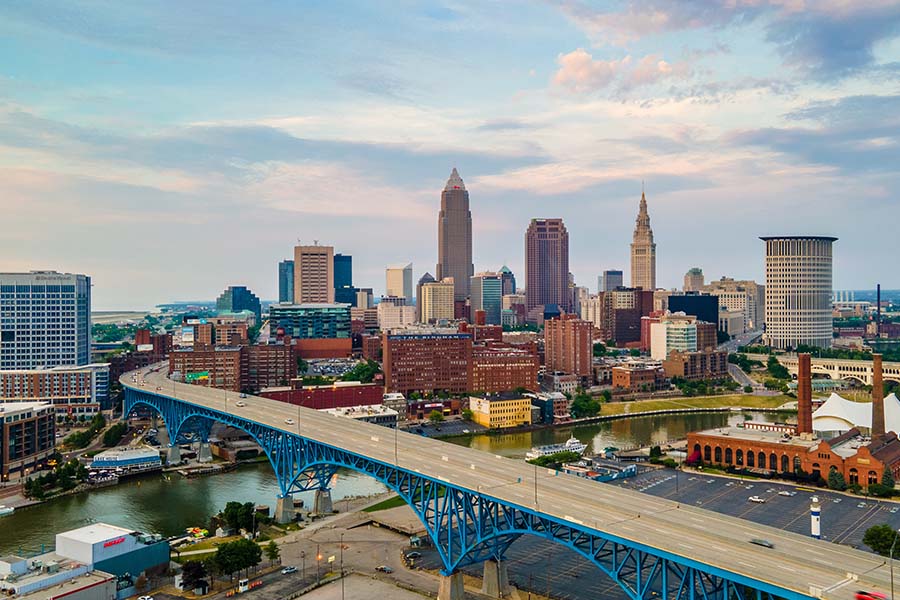 Cleveland OH - Aerial View of Downtown Cleveland Ohio at Sunset with Views of Tall Skyscrapers and a Modern Bridge Over the River