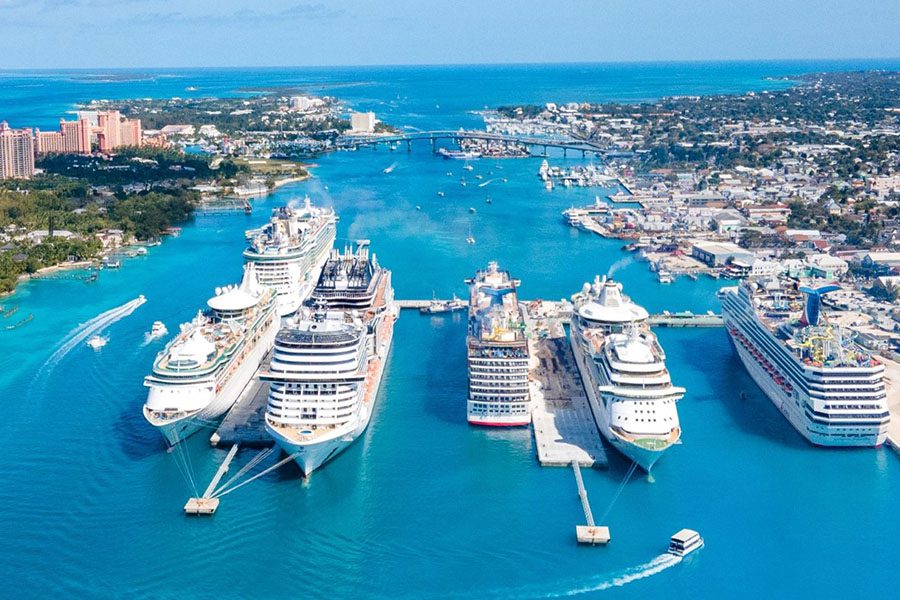 Ports and Terminals - Large Cargo Ships Pulling into Ports and Terminals at a City by the Ocean on a Beautiful Sunny Day